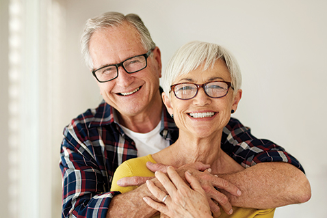 A married couple smiling. Links to Closely Held Business Stock
