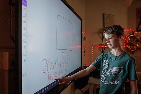 A student solving a math problem. Link to Life Stage Gift Planner Over Age 65 Situations.